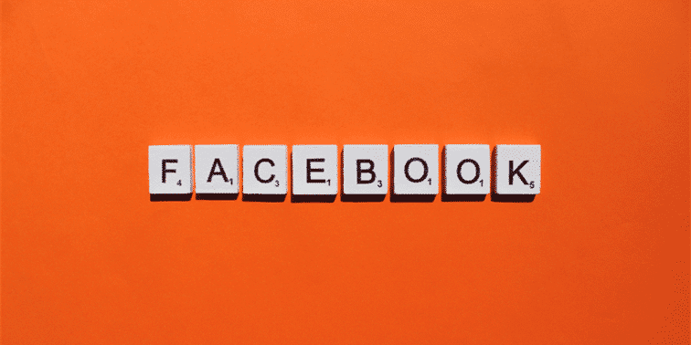 Facebook logo in white letters on an orange background, representing the social media platform's branding in the context of the upcoming Facebook News feature launch in the UK.