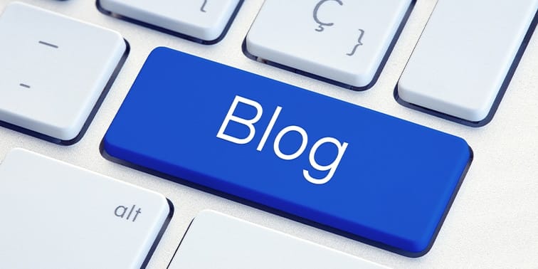 Blog key on a blue computer keyboard, emphasizing the importance of blogging for SEO strategies in digital marketing.
