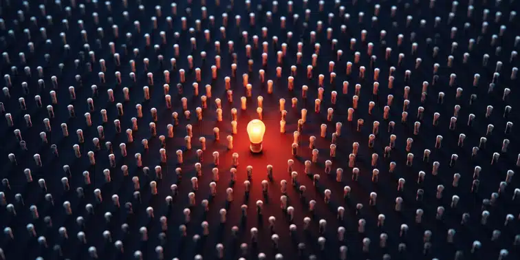 Light bulb surrounded by numerous pins, symbolising standout ideas in video marketing for small to medium businesses.