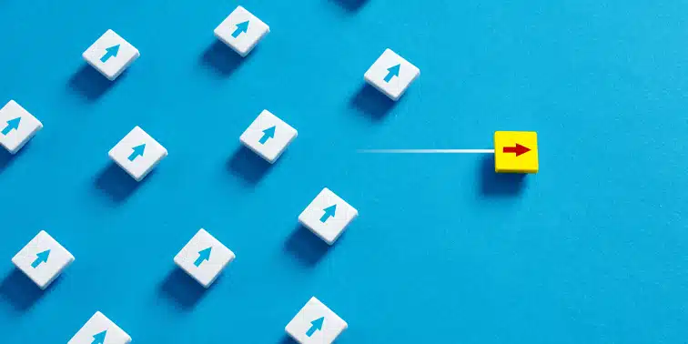 Yellow block with red arrow amidst white blocks with upward arrows on blue background, symbolising innovative strategies in digital marketing for lead generation.