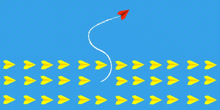 Red paper airplane flying against a backdrop of yellow paper airplanes, symbolising innovative lead generation strategies in digital marketing.