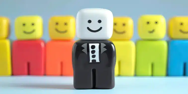 Smiling character in tuxedo standing out among colourful block figures, symbolising unique branding in digital marketing.