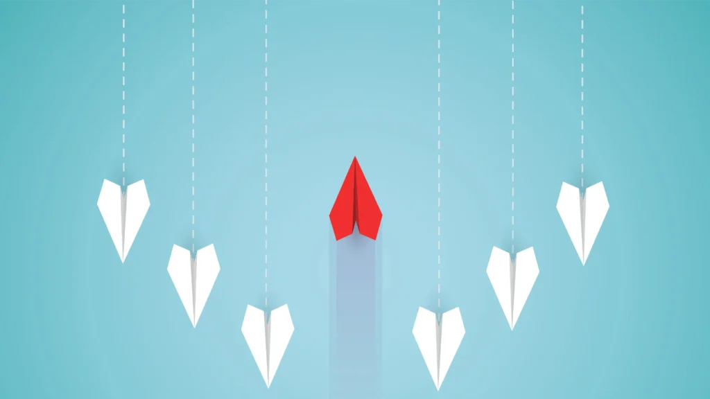 Red Paper Plane Flying in the Opposite Direction to the other white plane - Smart Cow Marketing Email Marketing Agency