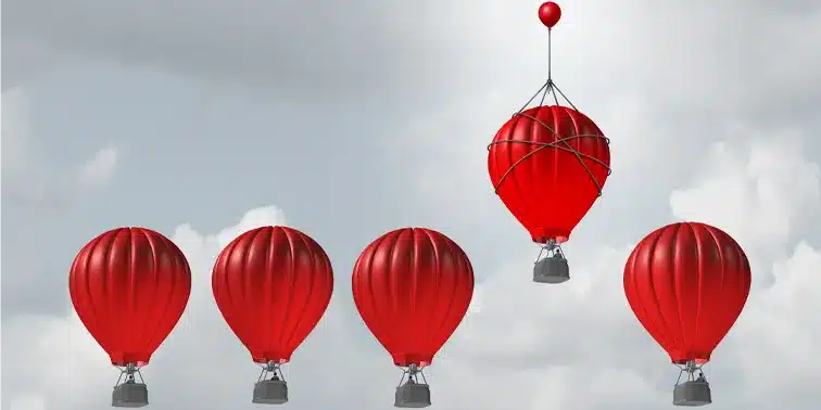 Red hot air balloons floating against a cloudy sky, symbolising growth and elevation in digital marketing strategies for small businesses.