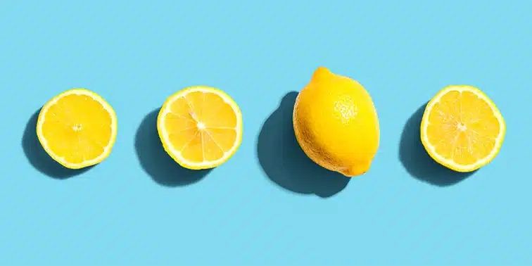 Sliced lemons and a whole lemon on a bright blue background, symbolising freshness and creativity in digital marketing strategies.